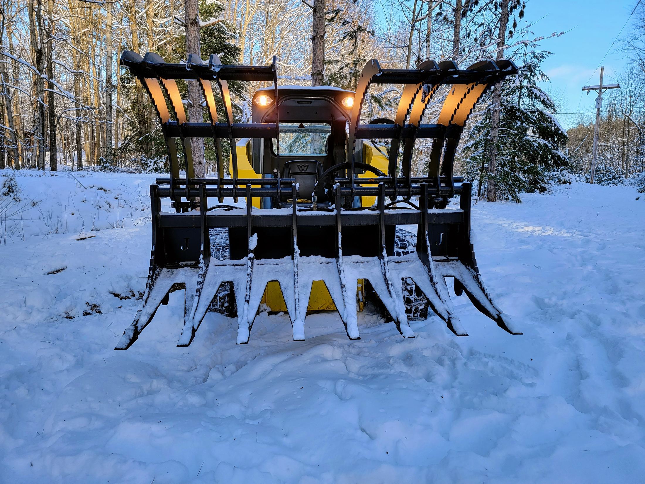 Jenkins Heavy Duty Dual Top Rake Grapple in the snow, lights on