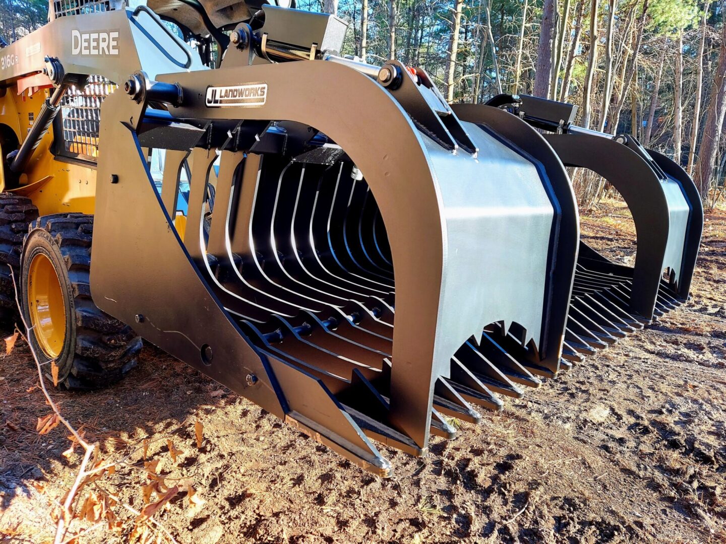 A close up of the front end of a large grapple bucket.