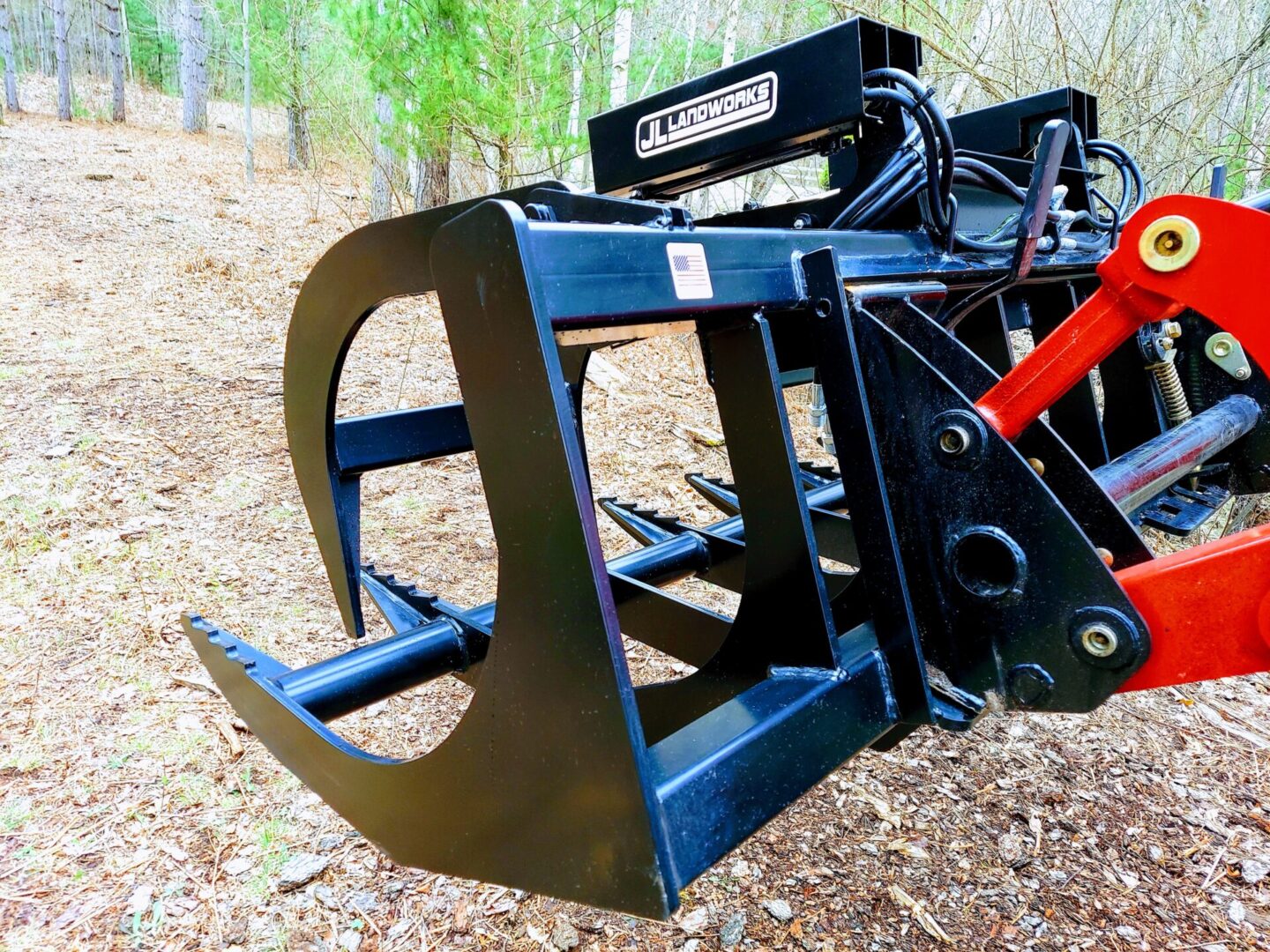 A close up of the back end of a tractor mounted grapple