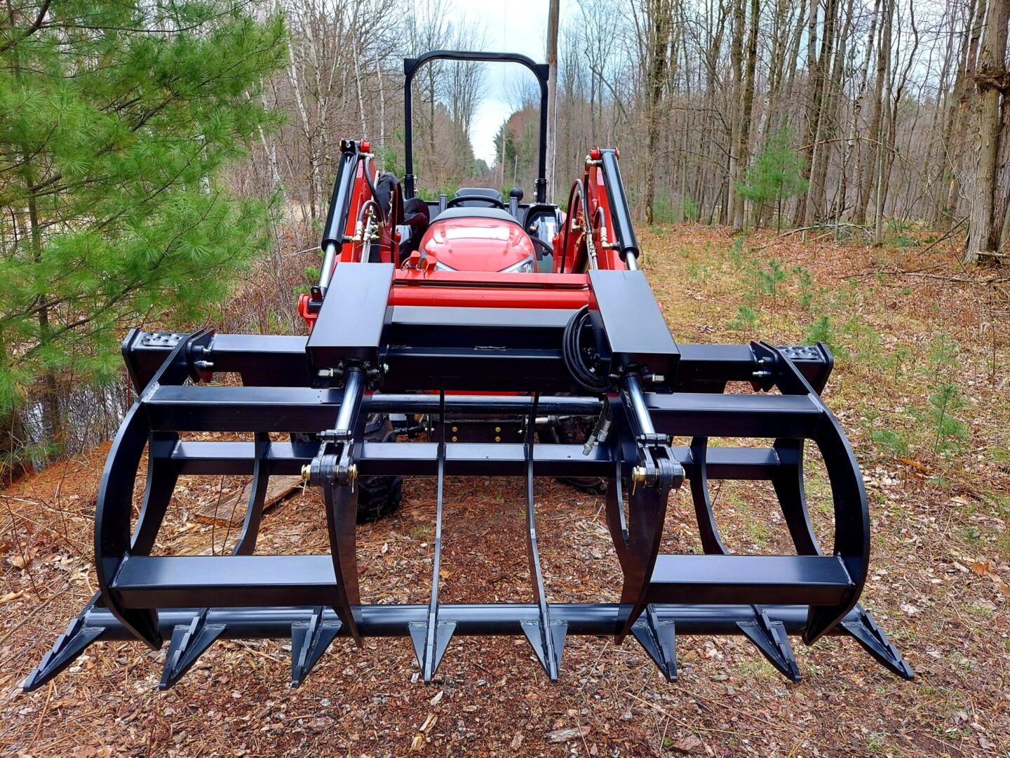 A red tractor with a large metal frame.