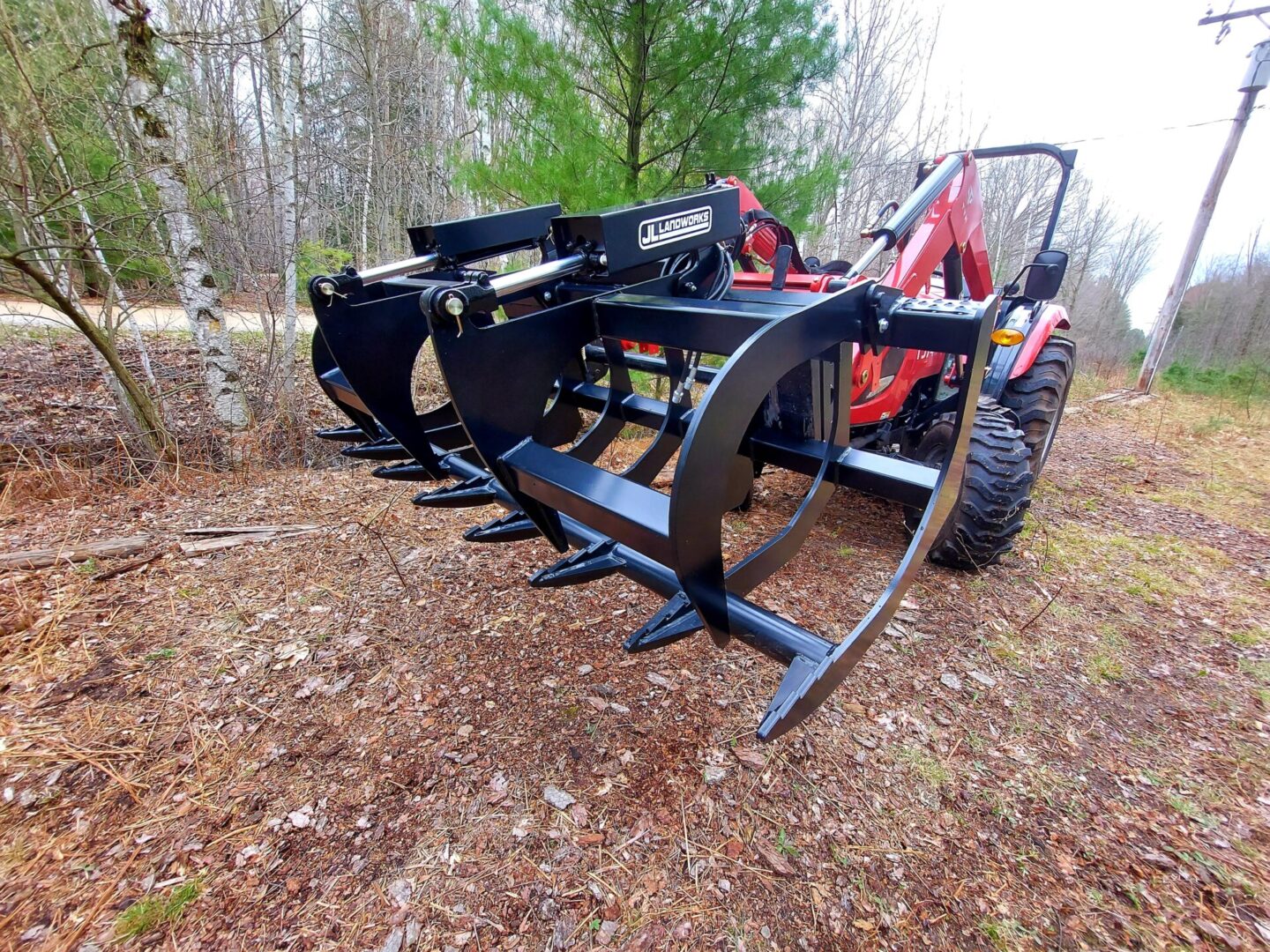 A tractor with a plow in the middle of a field.