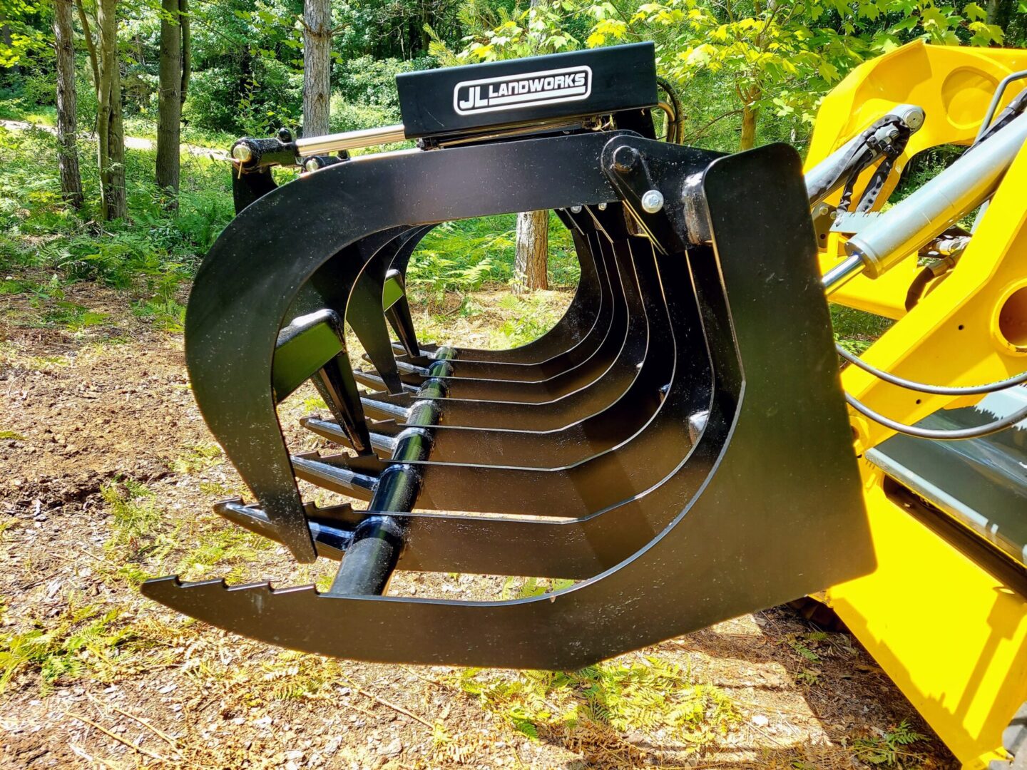 A close up of the back end of a yellow tractor