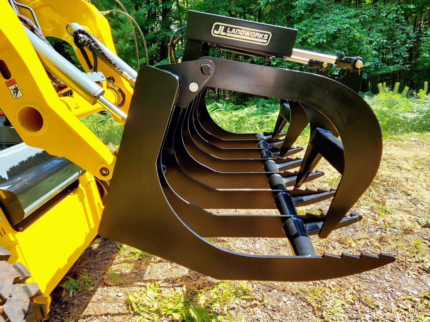 A close up of the back end of a yellow tractor