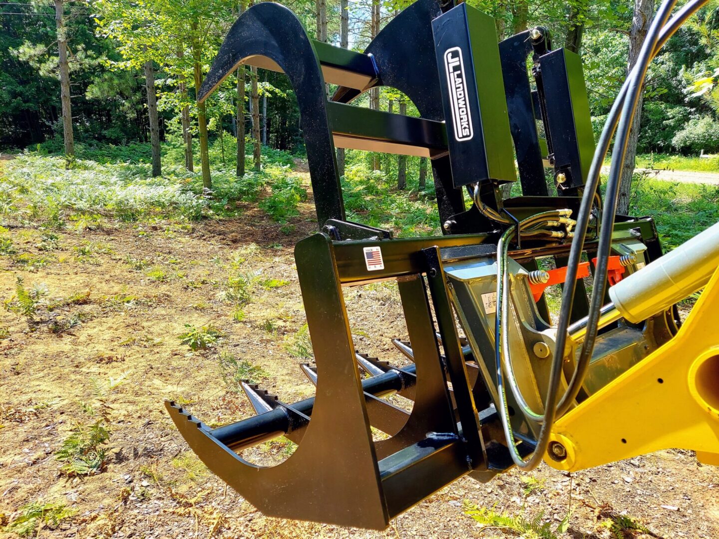 A close up of the back end of a tractor mounted grapple.