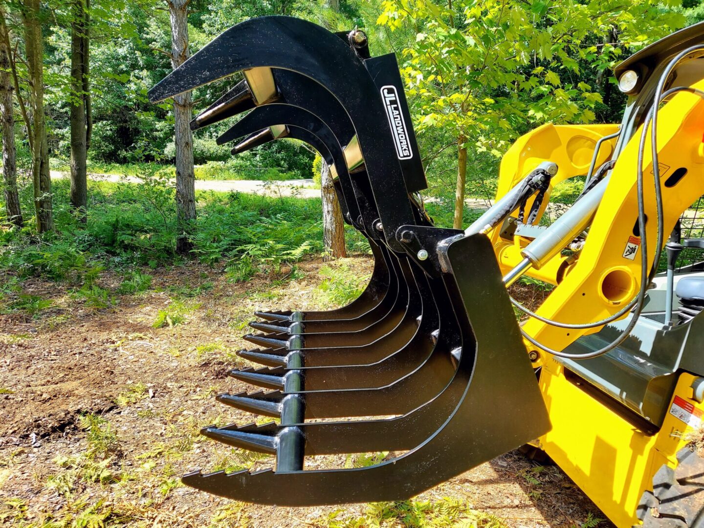 A close up of the back end of a yellow tractor