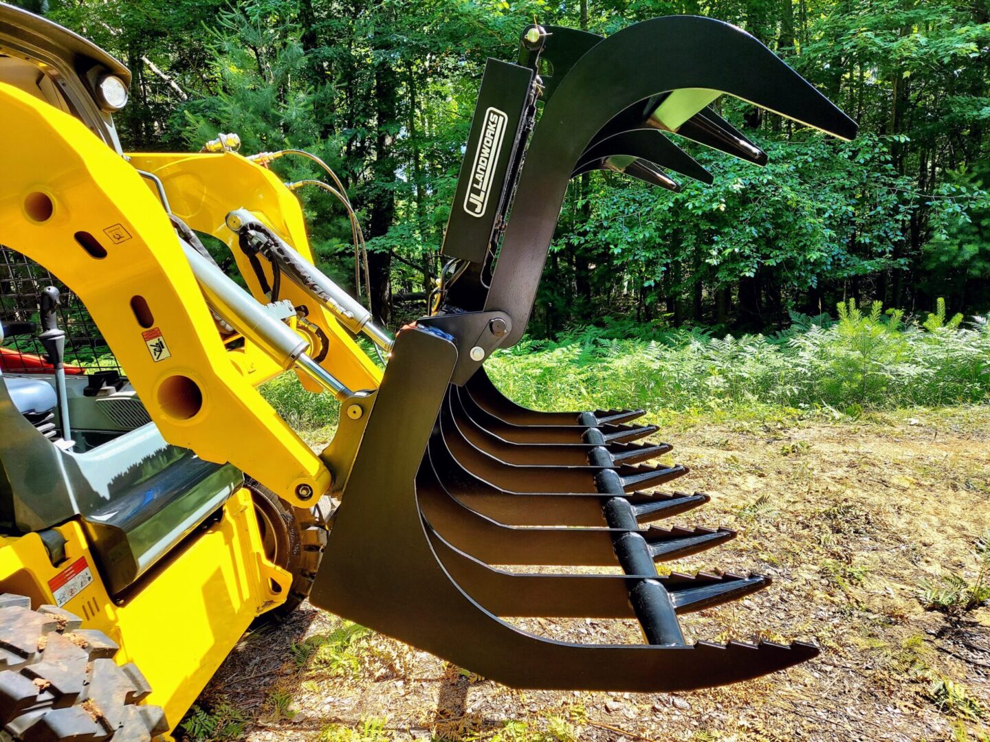 A yellow and black tractor with a large claw.