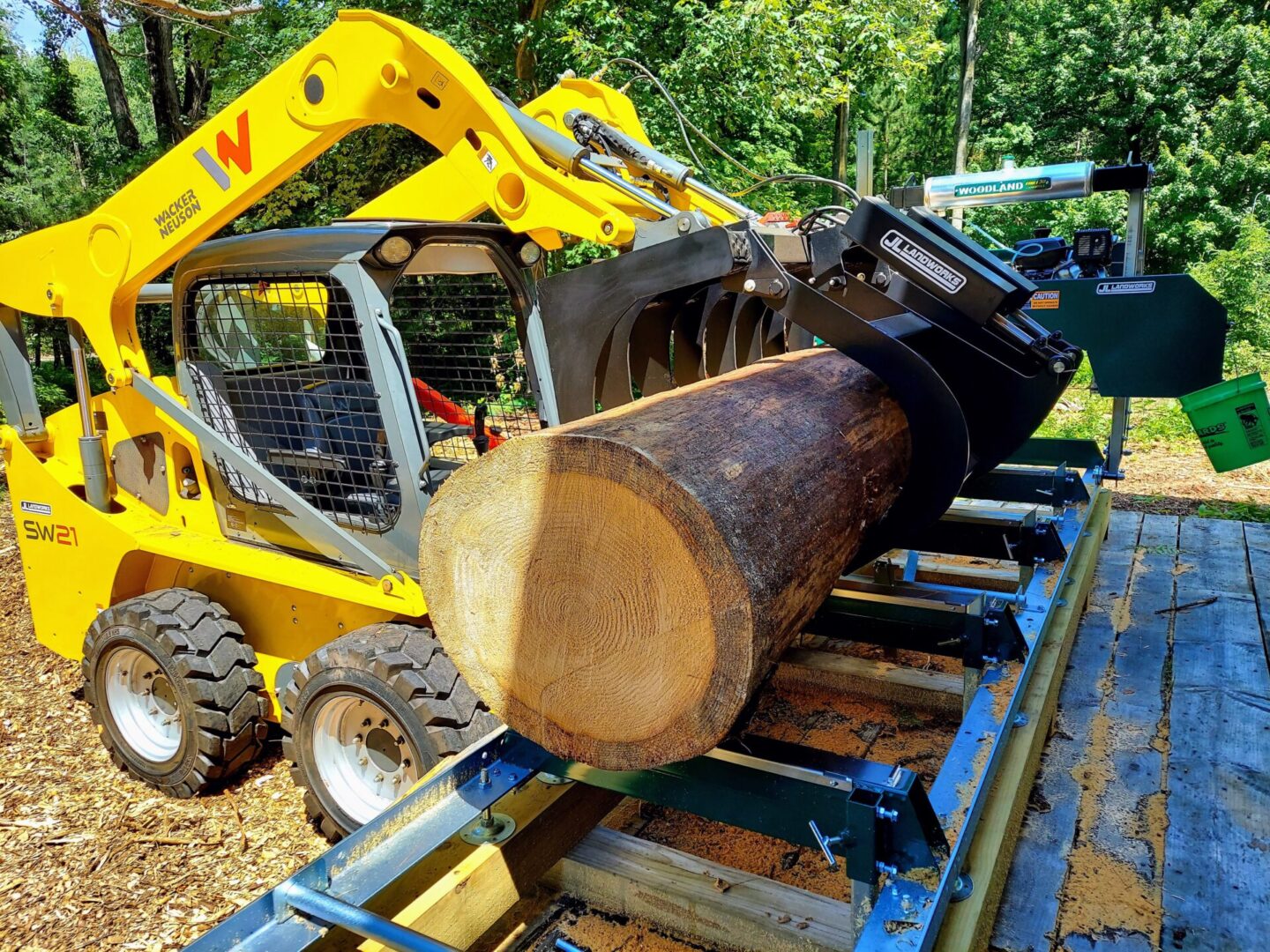 A yellow tractor with a log on it