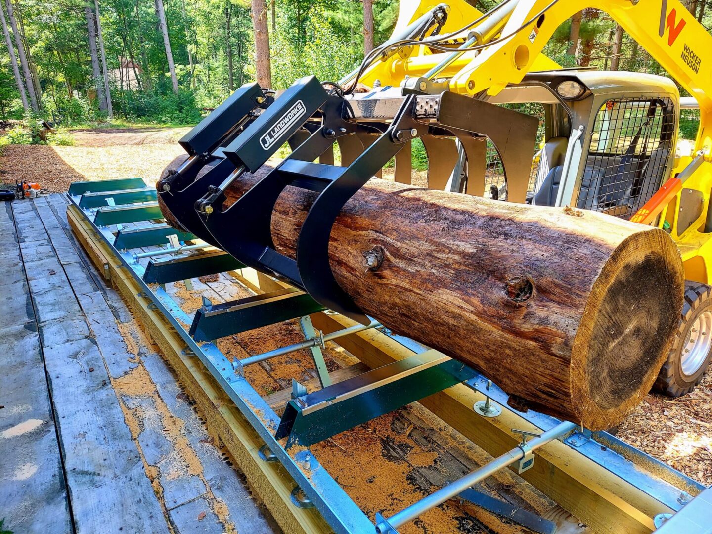 A log being cut with a large machine.