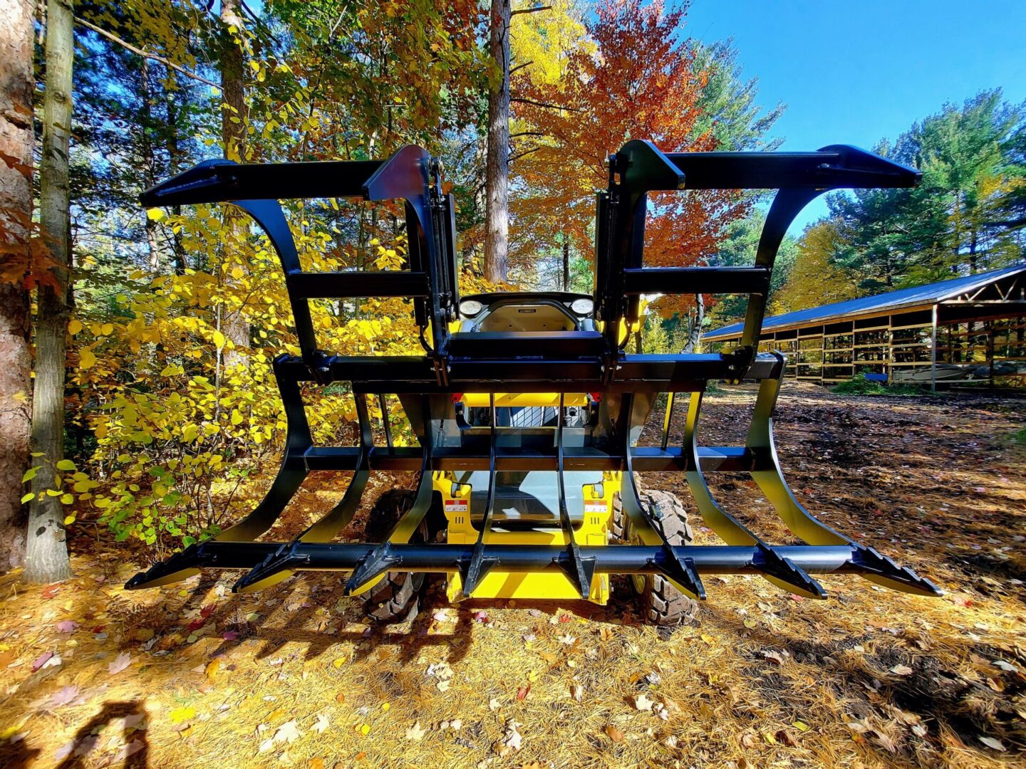 A tractor with a yellow seat in the middle of a field.