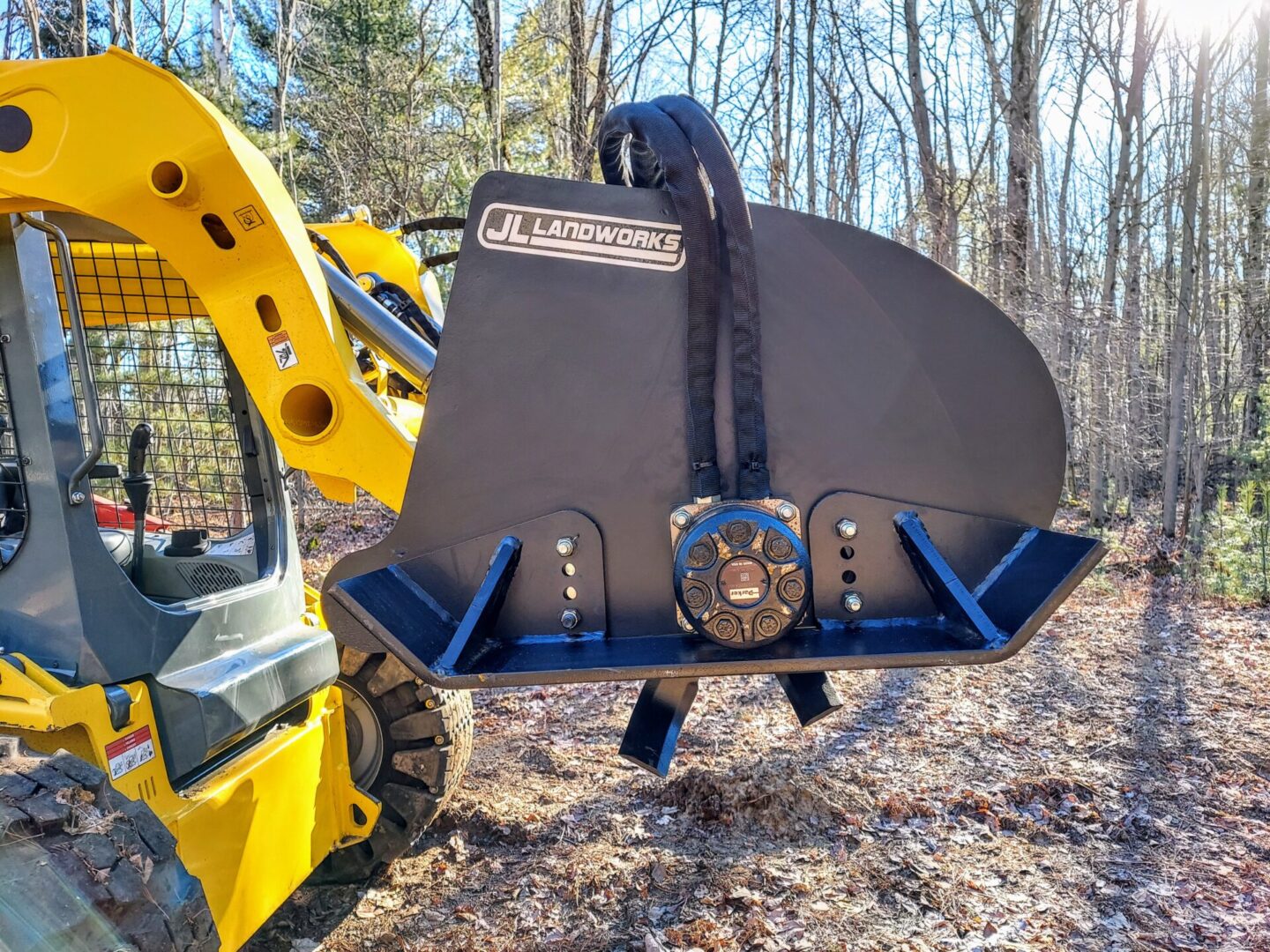 A yellow and black tractor with a blue plow