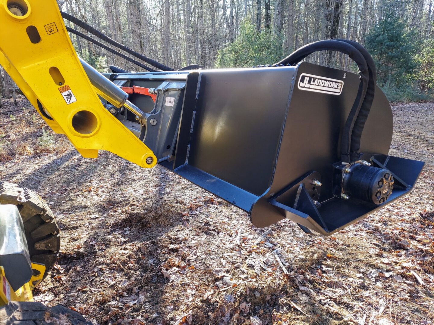 A yellow and black machine in the woods