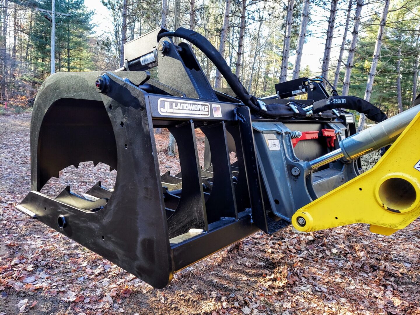 A large yellow and black machine in the woods.