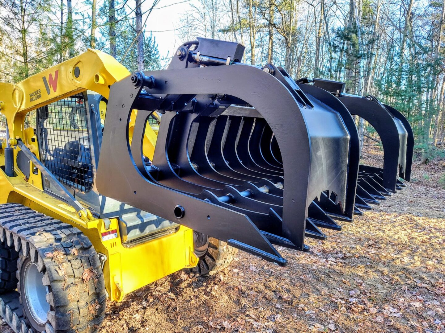 A yellow tractor with a large black claw.