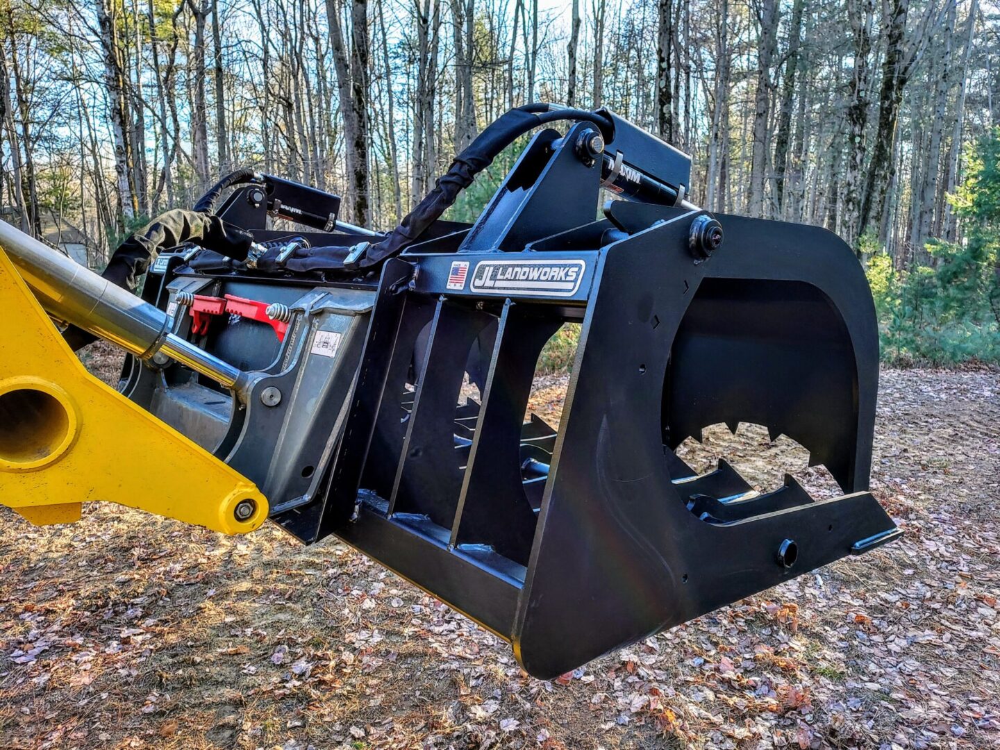 A large black and yellow machine in the woods.