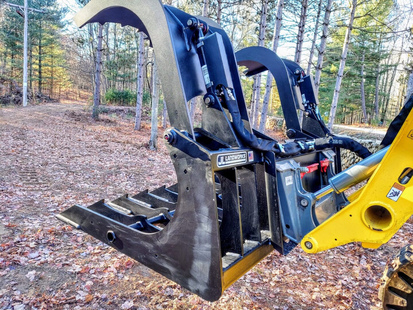 A close up of the back end of a machine in the woods.