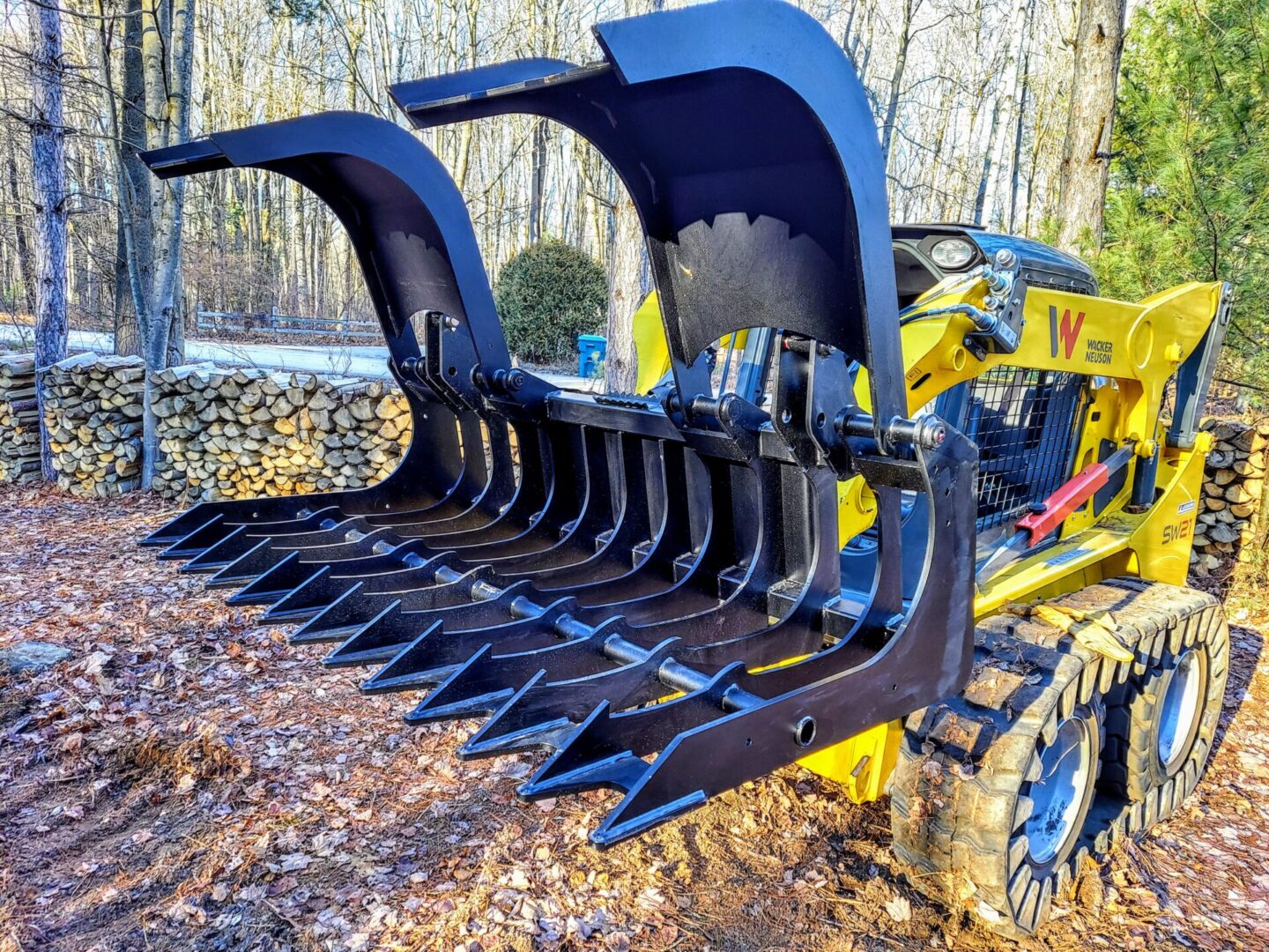 A yellow and black tractor with a large claw.