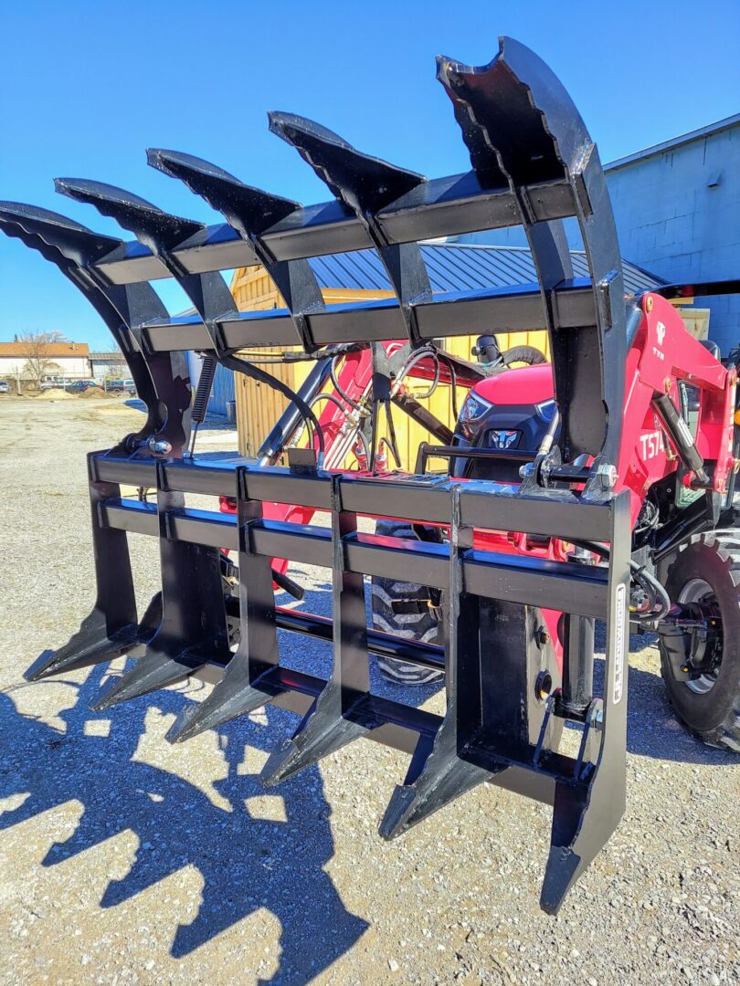 A tractor with a large black metal fence.