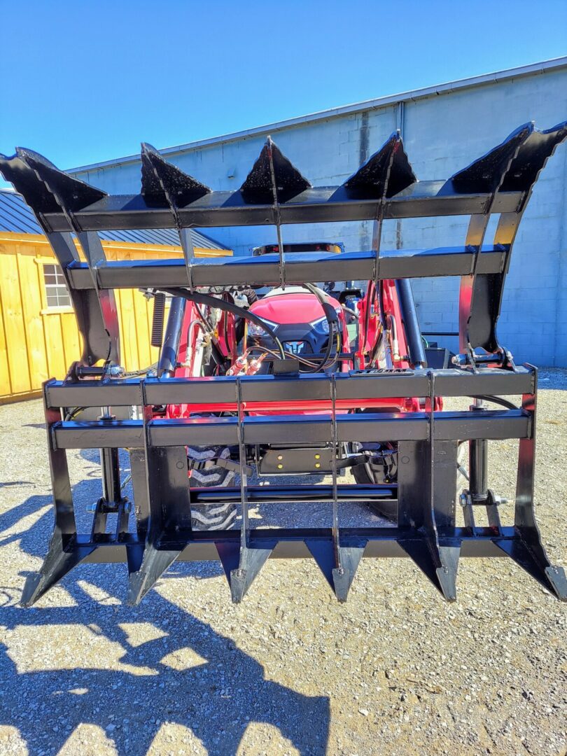 A red tractor with a large metal frame.