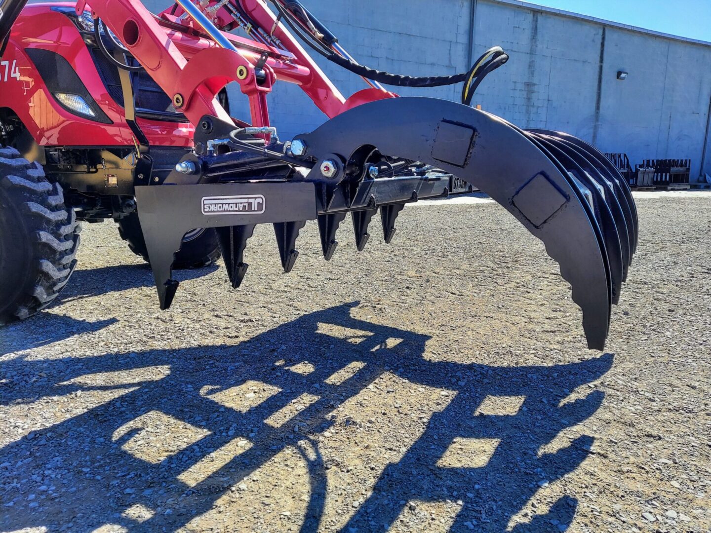 A close up of the side of a tractor with a grapple