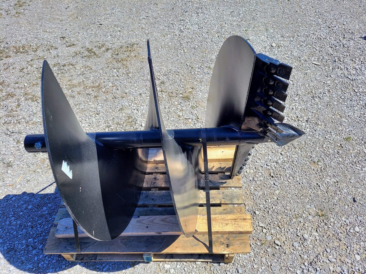 A pair of metal blades sitting on top of a pallet.