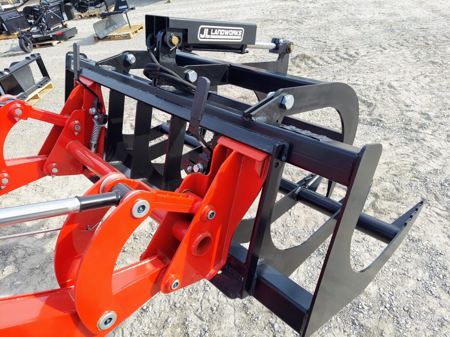 A red and black tractor with a fork in it