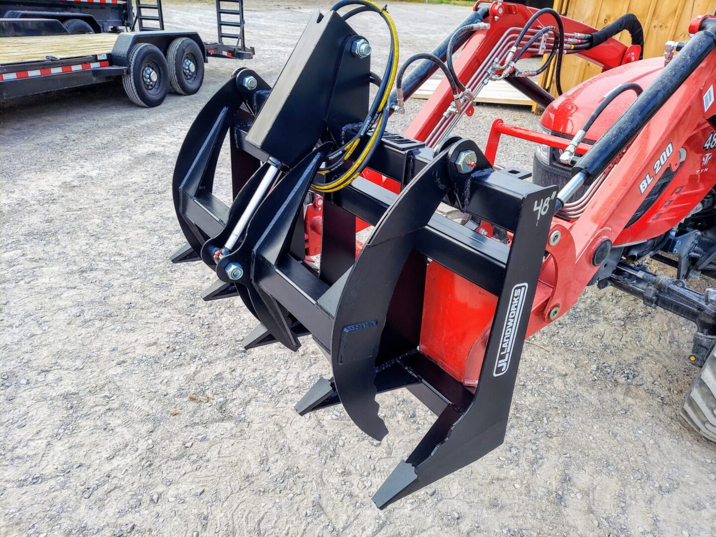 A tractor with two forks attached to it.