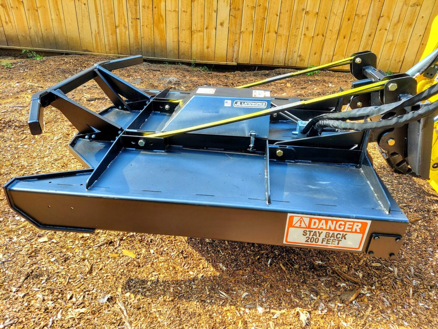 A blue mower sitting on top of the ground.