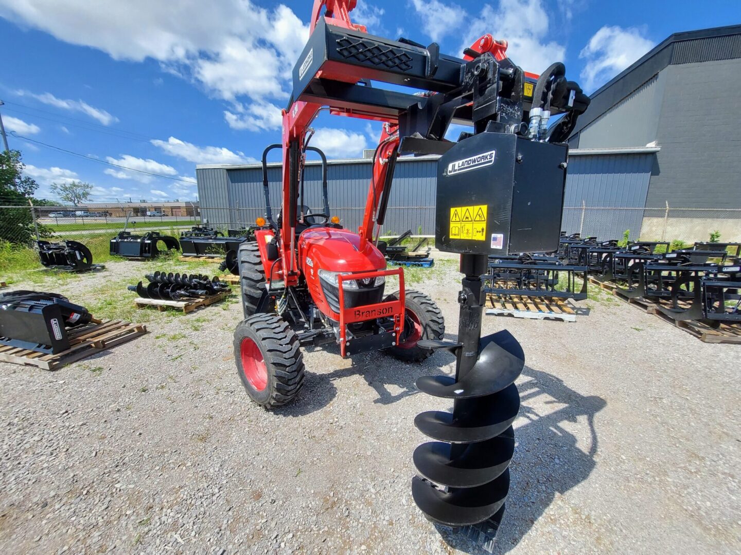 A red tractor with a black post and a blue sky