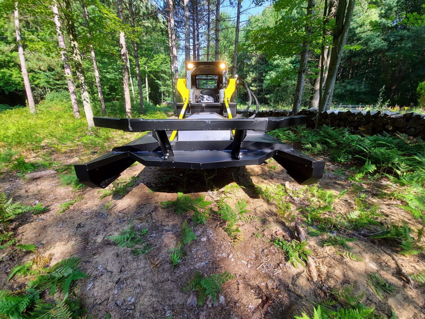 A tractor is parked in the middle of a forest.