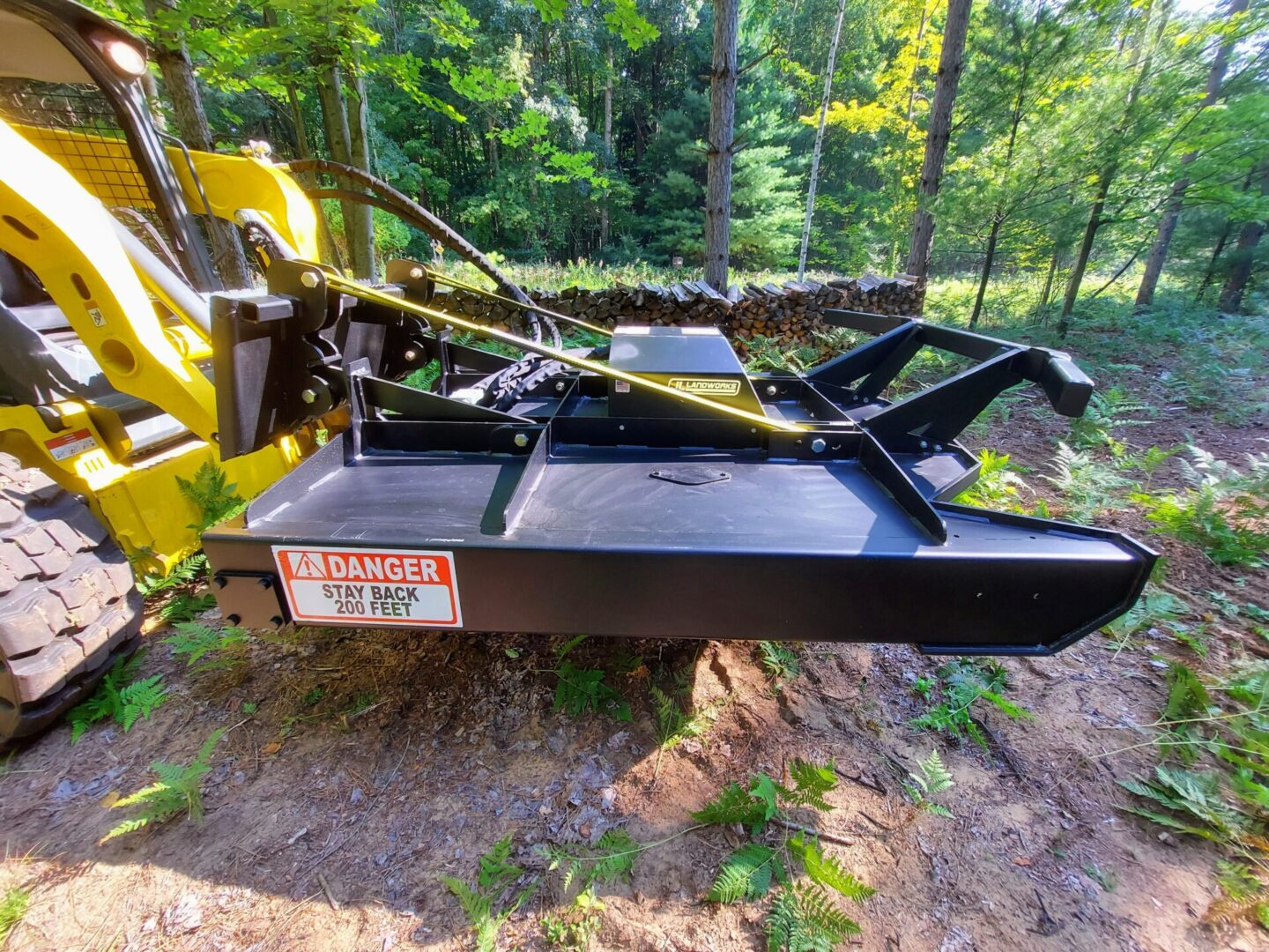 A yellow and black tractor is parked on the ground