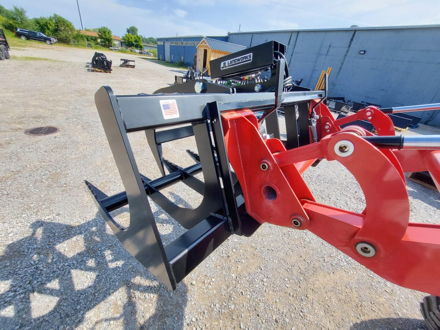 A red and black tractor with a fork lift.