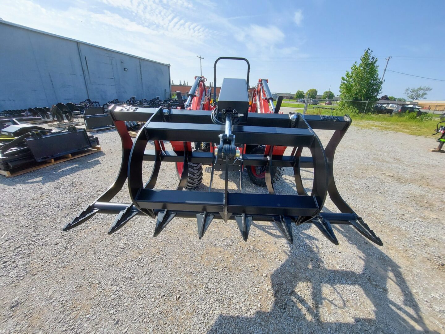 A tractor with a large claw attachment on the back.