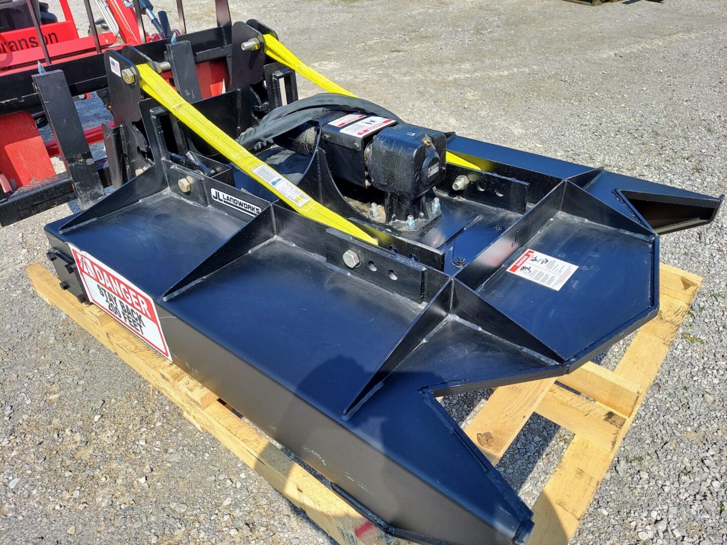 A blue machine is sitting on some wood