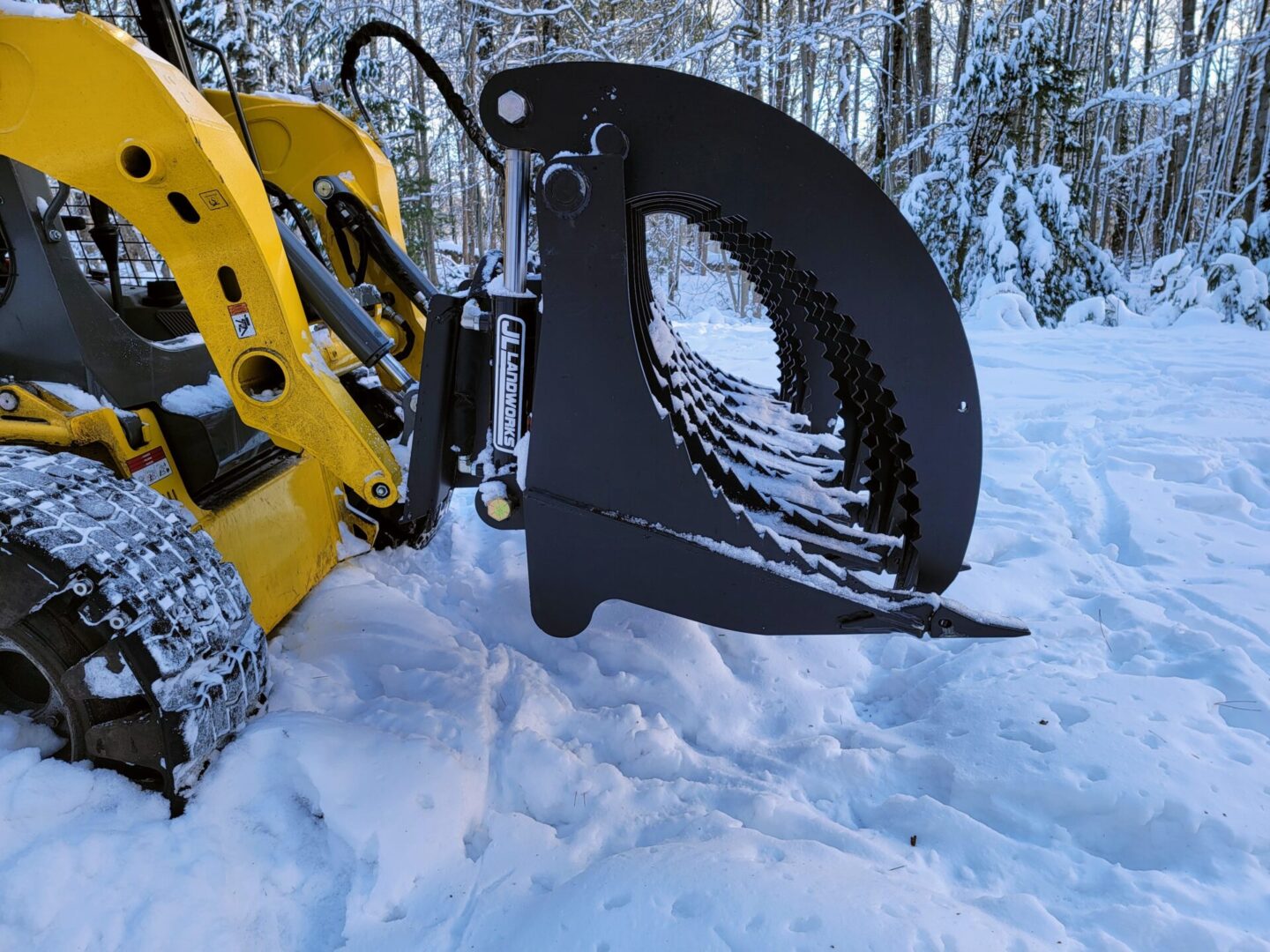 A yellow and black machine in the snow.