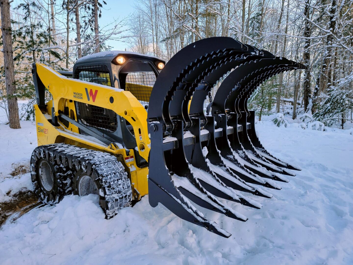 A yellow and black tractor is in the snow