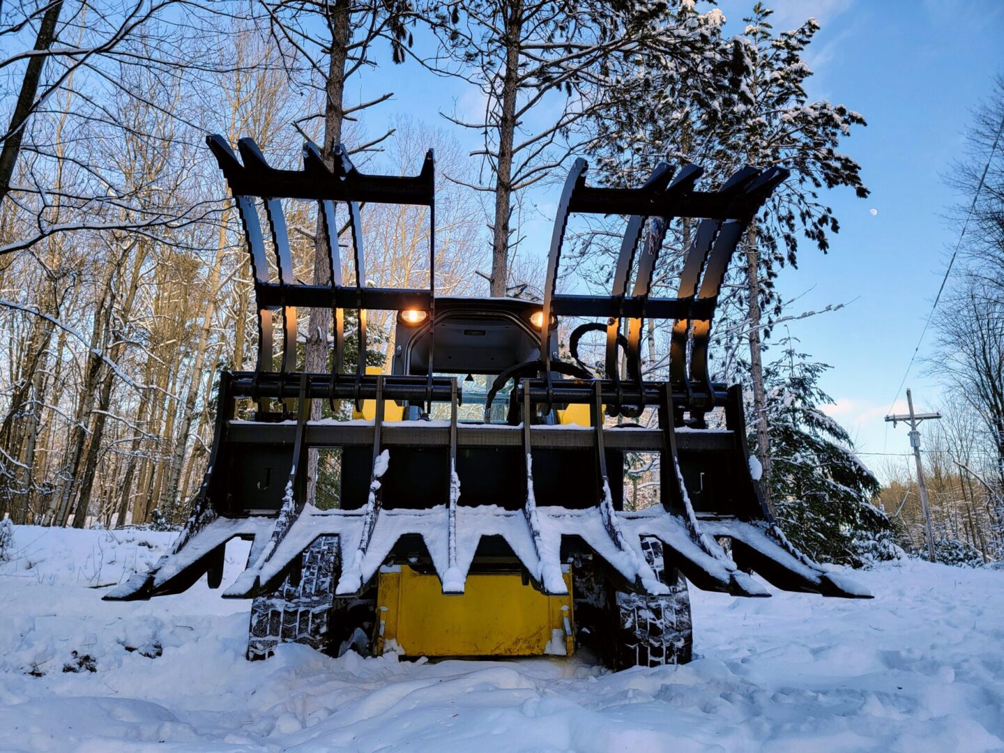 A snow plow is parked in the snow.