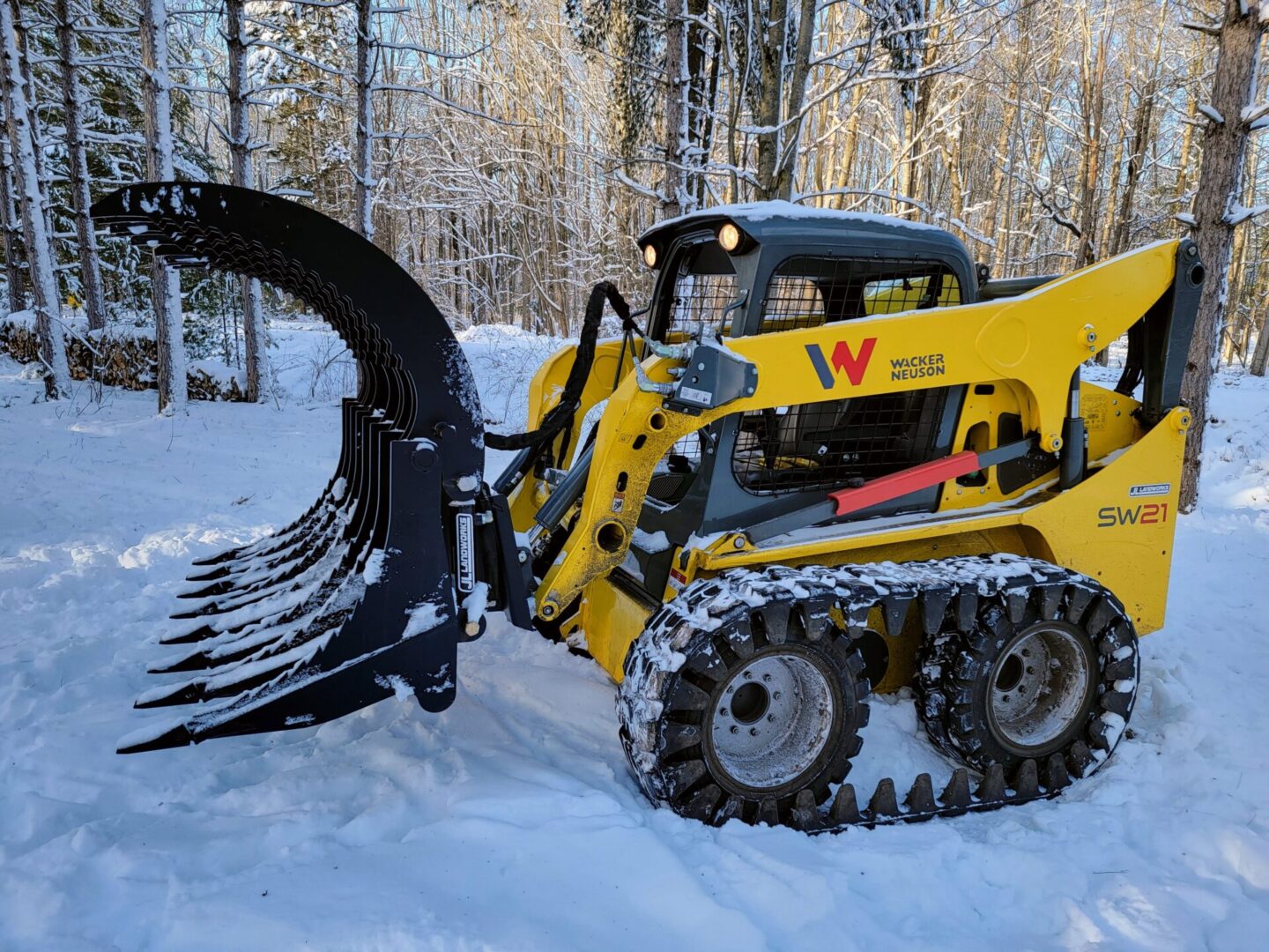 A yellow and black tractor is in the snow