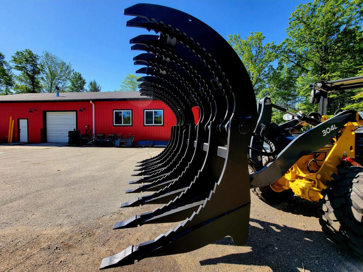 A tractor with a large metal blade in front of it.