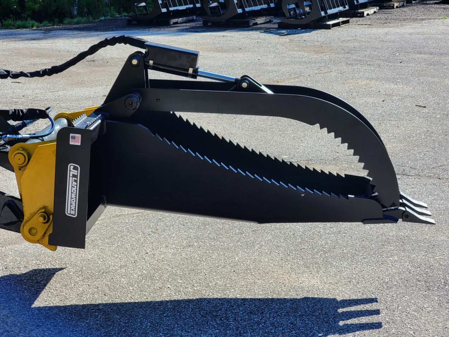 A large black saw blade sitting on top of concrete.