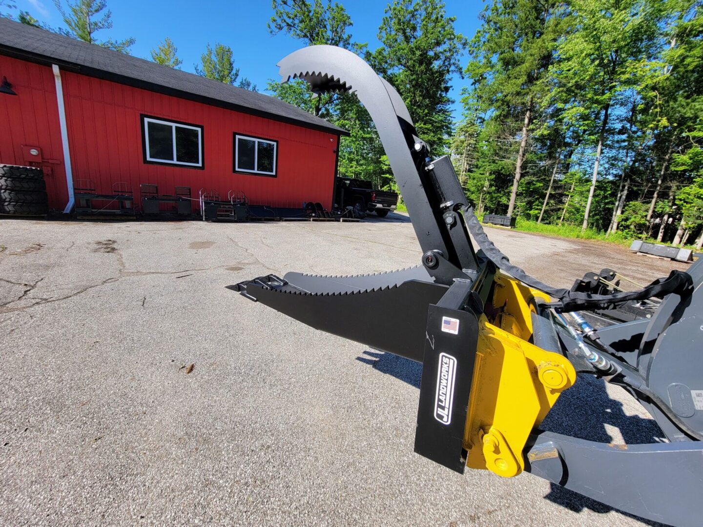 A yellow and black plow sitting in the dirt.