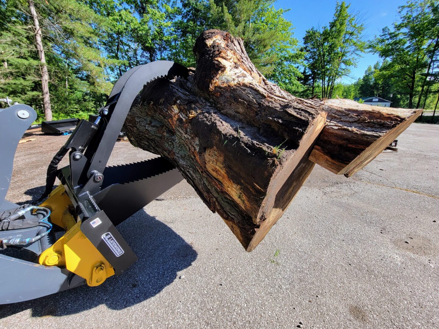 A large piece of wood is being held by a crane.