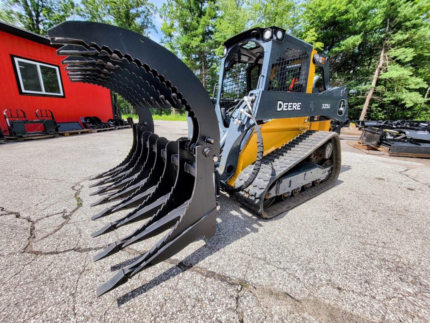 A large black and yellow tractor with a big metal claw.