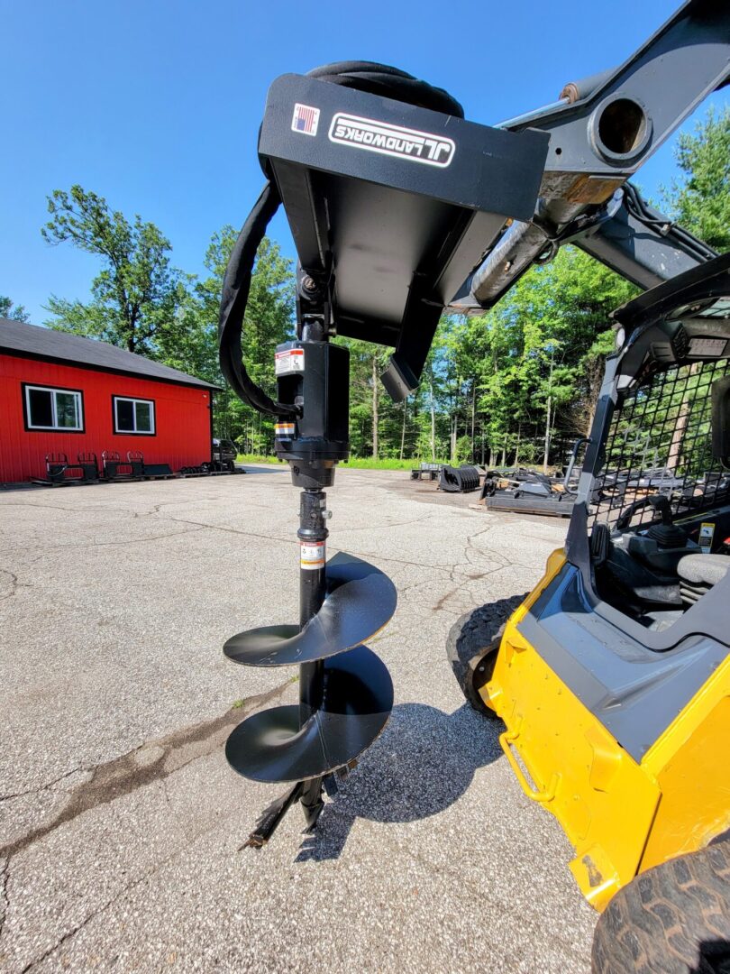 A close up of the front of a yellow and black tractor.