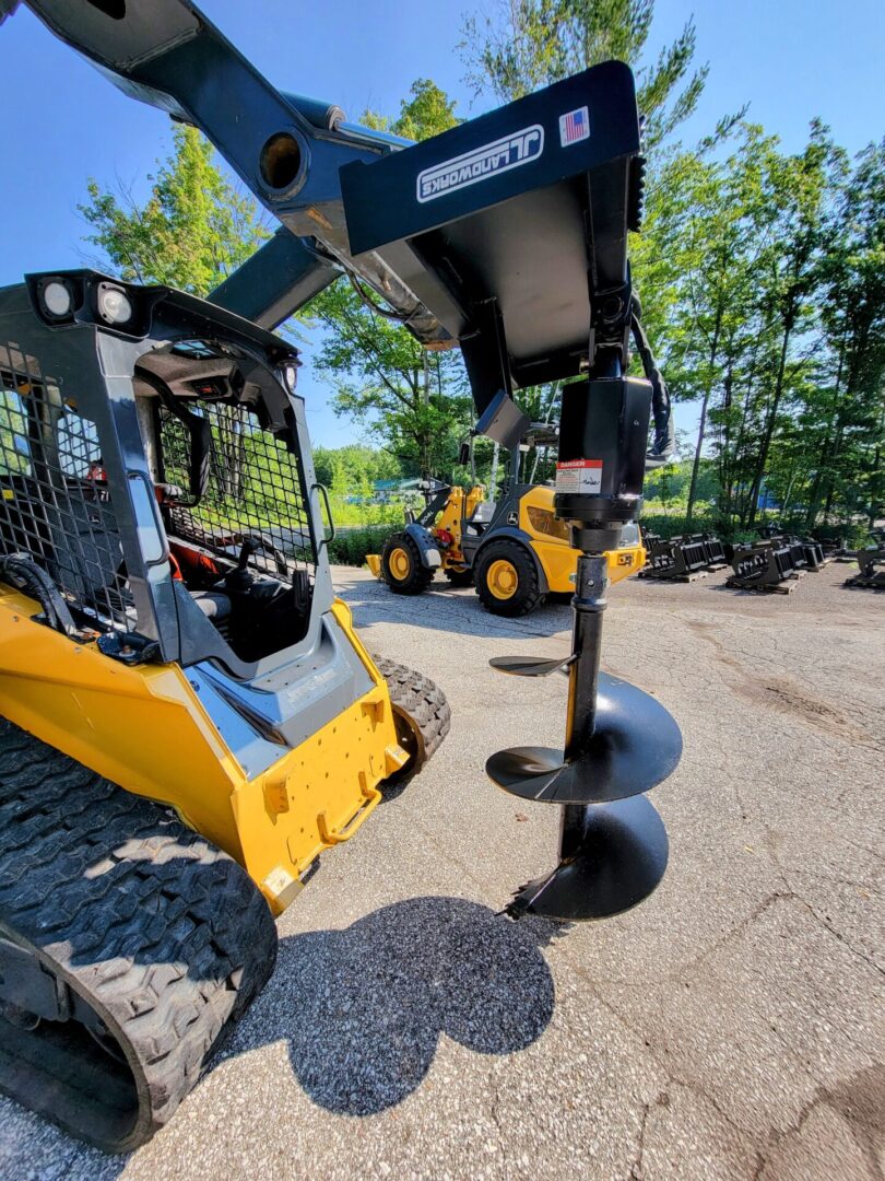 A group of construction equipment parked in the dirt.