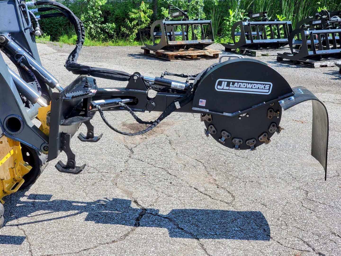 A close up of the side of a tractor with a plow attachment.