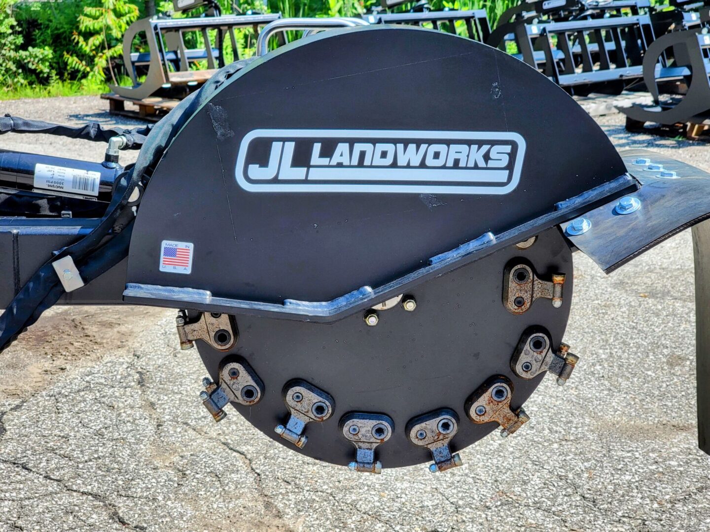 A large black disc with the logo of j. L. Landworks on it