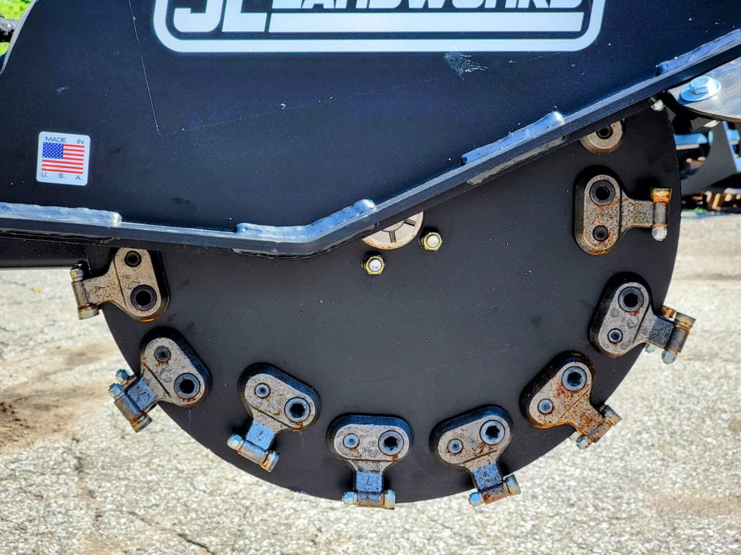 A close up of the back of a disc mower