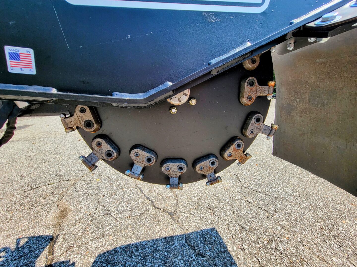 A close up of the blade on a disc mower