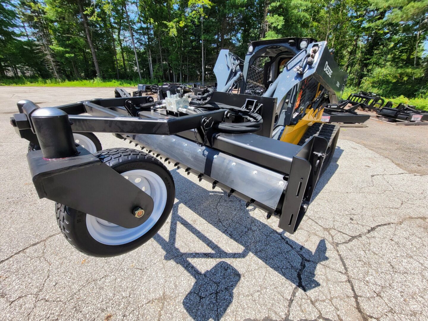 A tractor with a plow attachment on the ground.