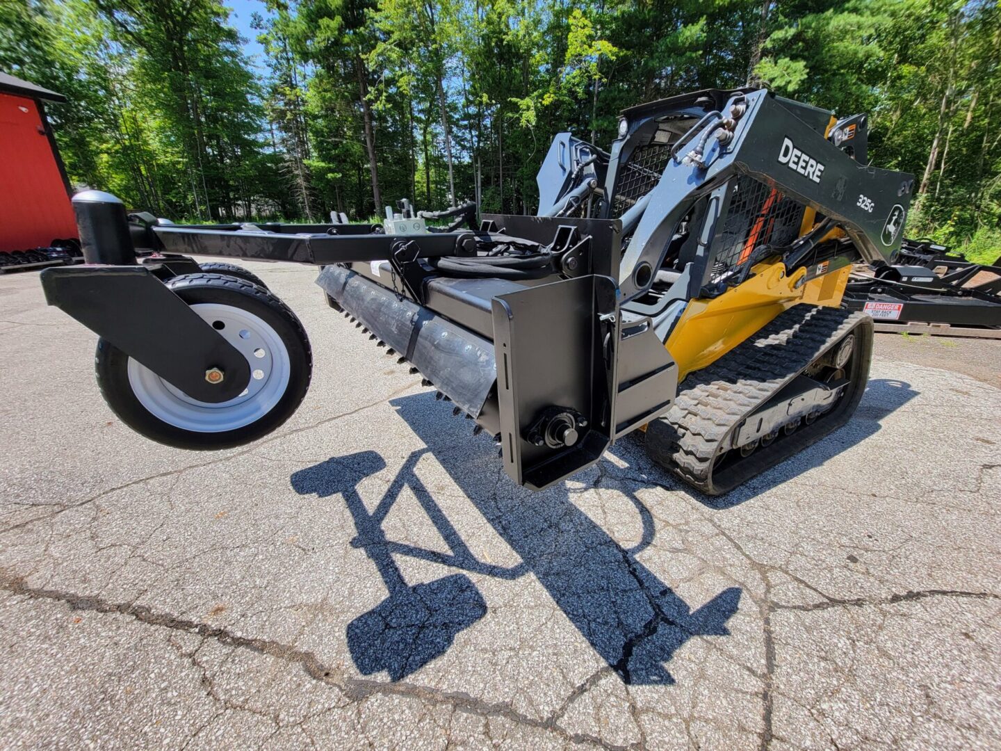 A close up of the back end of a skid steer with attachments.